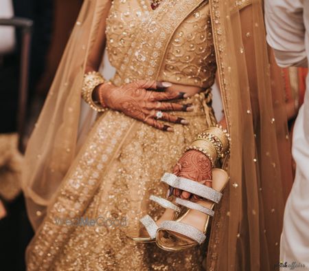 Photo of Bridal close up shot holding shoes