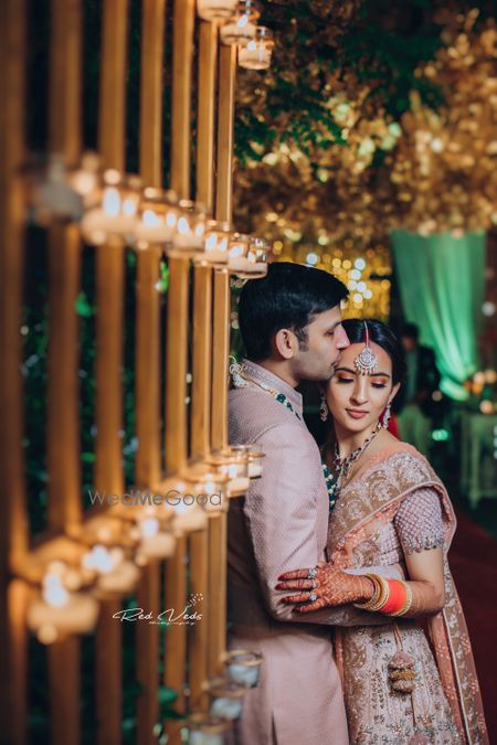 Photo of A bride and groom in coordinate pink outfits for their wedding