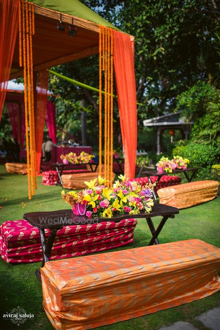 Photo of Mehendi decor in orange and gold