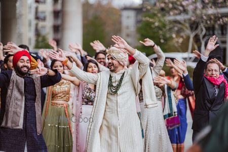 Photo of groom baraat entry idea with the whole family dancing