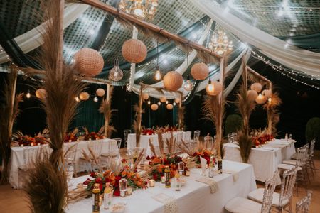 Photo of outdoor table setting with white and gold decoration