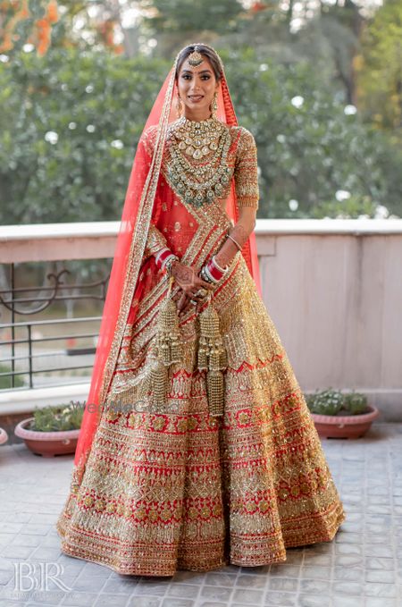 Photo of Red and gold bridal lehenga heavy by Manish Malhotra