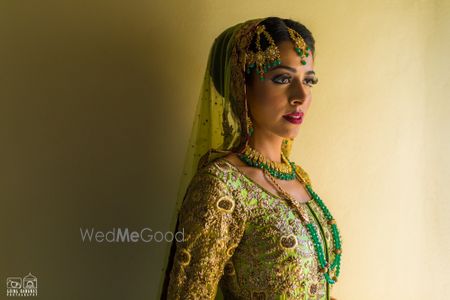 Photo of Offbeat bride in green lehenga and jewellery