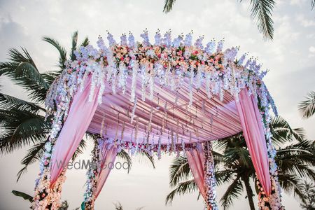 Photo of Circular mandap decor with florals and light pink fabric