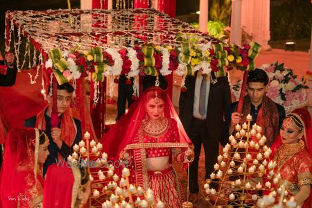 Photo of Bridal entry with tea lights & under a phoolon ki chaadar