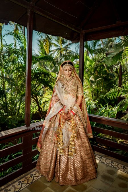 Photo of offbeat burnt orange bridal lehenga with floral dupatta