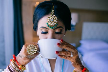 Photo of Bride drinking coffee getting ready shot idea