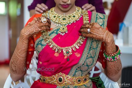 Photo of South Indian bridal jewellery with layered necklaces and waist belt