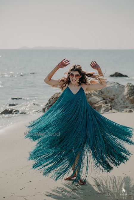 Photo of The bride in a flowy outfit perfect for the pool party