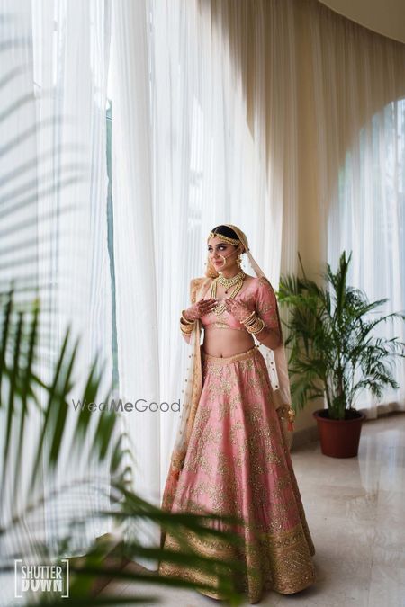 Photo of Light pink bridal lehenga portrait idea