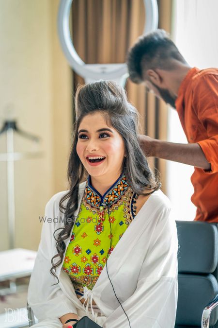 Photo of Bride getting hair done up on mehendi