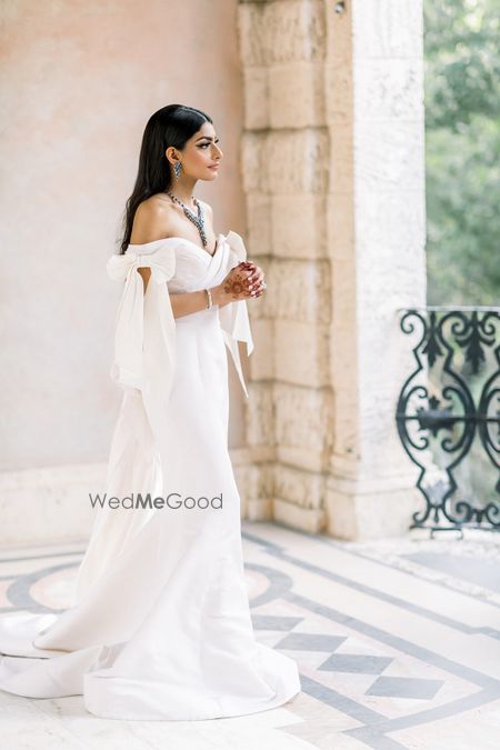 Photo of Off shoulder white wedding gown with train