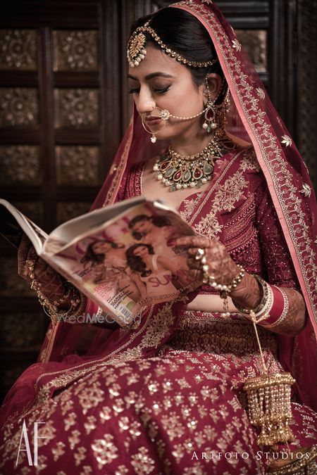 Photo of Getting ready bridal portrait reading magazine