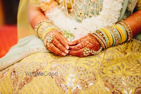 Photo of Bridal hands on yellow gota patti lehenga