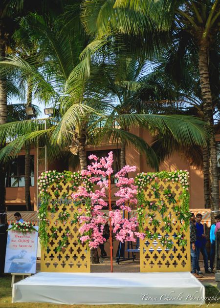 Photo of pink and gold and green outdoor small stage