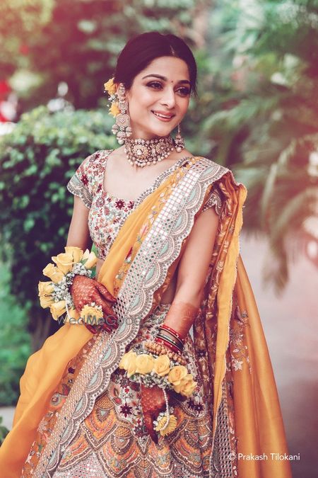 Photo of Bridal portrait in a yellow mehendi lehenga on her mehendi