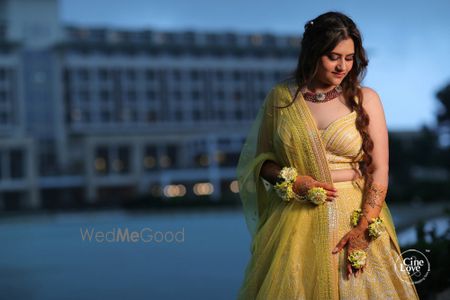 Photo of mehendi yellow lehenga with unique blouse design