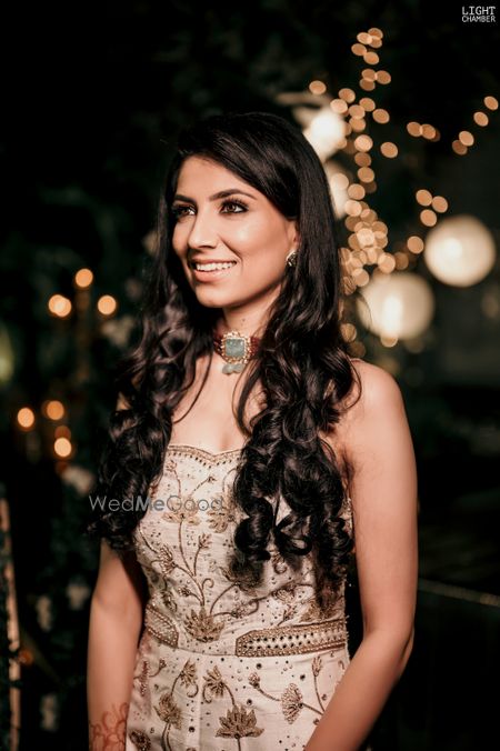 Photo of Bride wears white and gold jumpsuit on her engagement night