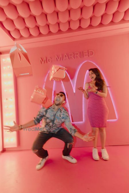 Photo of Fun McDonalds themed after party with the bride in a cute pink mini dress