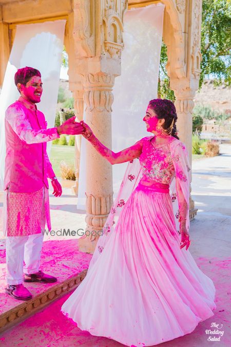 Photo of couple shot drenched in holi colours on their mehendi