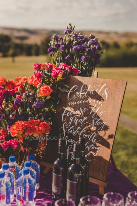 Photo of Rustic wooden bar sign at wedding