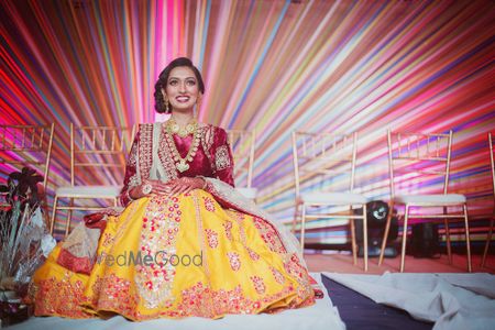 Photo of yelloa and deep red lehenga