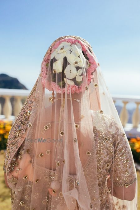 Photo of Beautiful bridal bun with white and pink flowers