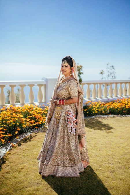 Photo of Pretty gold and beige lehenga with pom pom kaleere