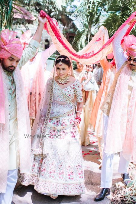 Photo of Bridal entry shot of the bride wearing white lehenga