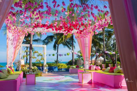 Photo of Mehendi decor in lime green and pink with floral strings