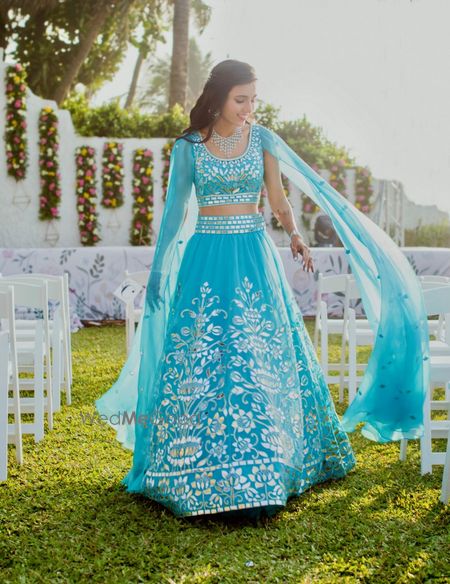 Photo of Turquoise lehenga with cape sleeves