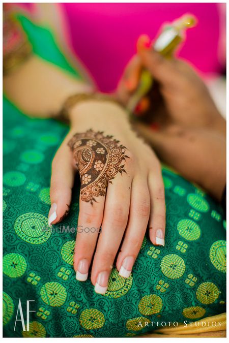 Photo of Intricate mehendi designs half full