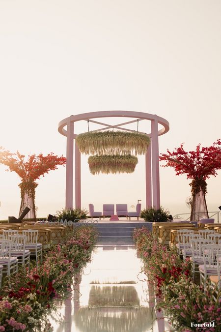 Photo of Gorgeous modern style pink and white outdoor mandap with floating floral decor