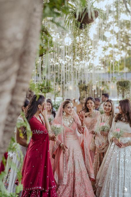 Photo of bride and her bridesmaids first look photos