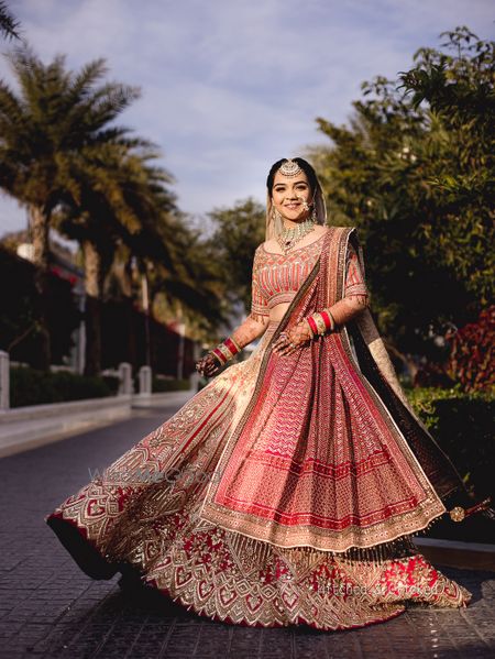 Photo of bridal lehenga twirling shot