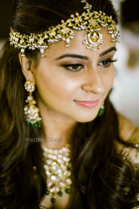 Photo of Unique bridal mathapatti with green beads