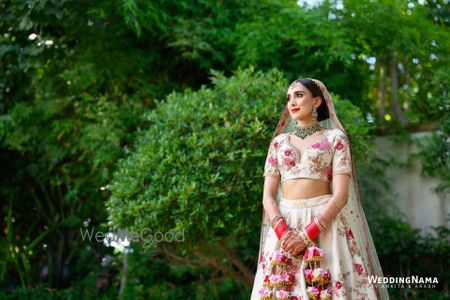 Photo of Bride wearing unique pink floral kaleeras