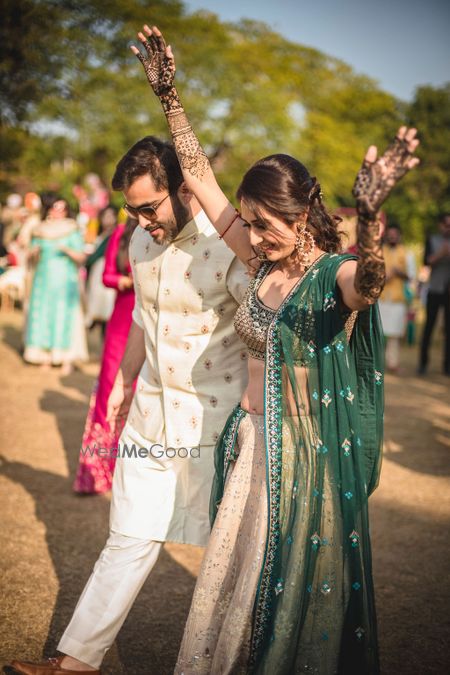 Photo of Happy bride shot on mehendi day in dark green