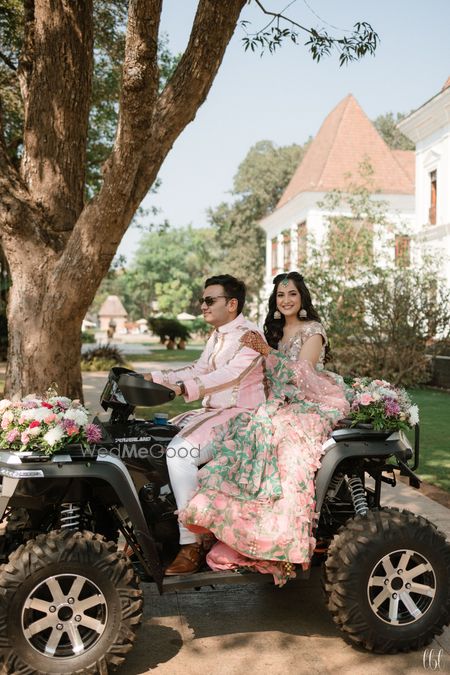 Photo of couple entry idea on the mehendi sitting on atv