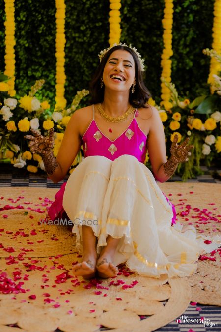 Photo of candid smiling shot of bride on her mehendi