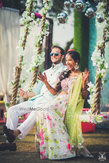 Photo of Cute couple portrait on mehendi swing