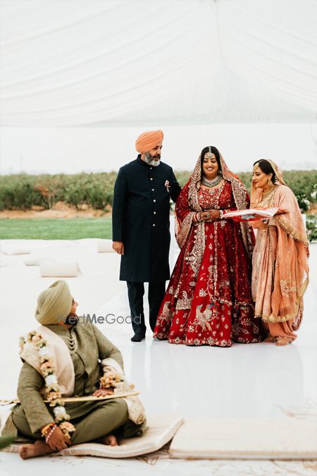 Photo of bridal entry idea with bride entering with her parents