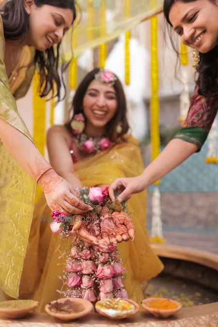 Photo of Unique Pose Idea for Bride and Bridesmaid on Haldi