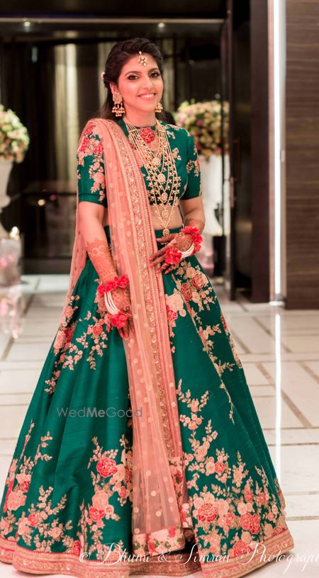 Photo of Green sabyasachi lehenga worn with 7 string necklace