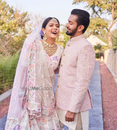 Photo of Coordinated couple in pastel wedding outfits