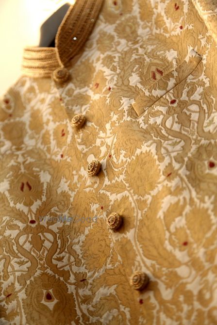 Photo of brocade sherwani in gold and white with gold buttons