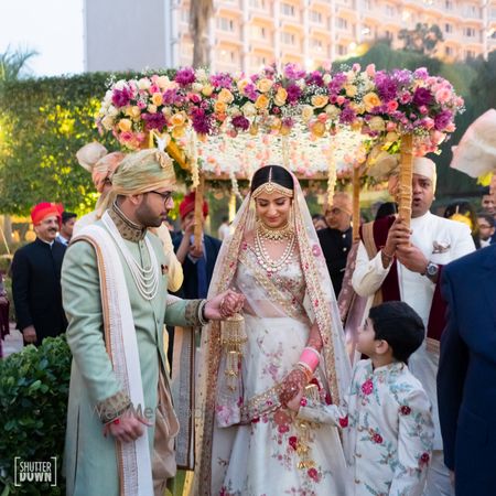 Photo of Bridal entry under phoolon ka chadar with multicolour flowers