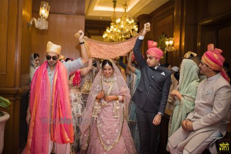 Photo of Bride entering under phoolon ki chaadar