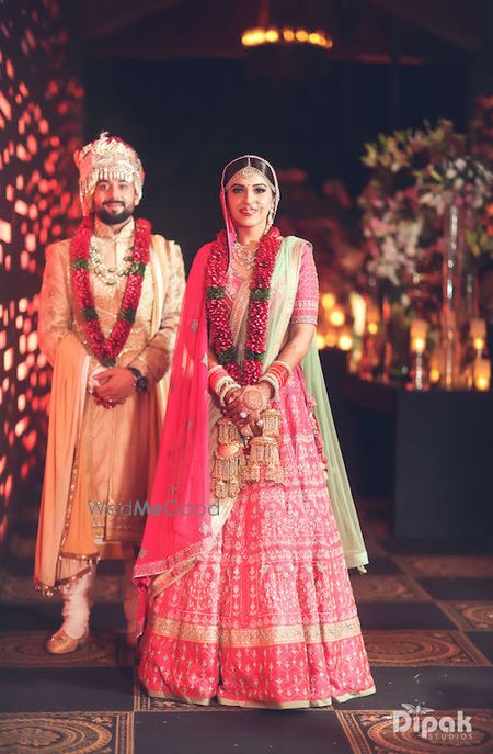 Photo of Bride and groom in coordinated outfits on their wedding day