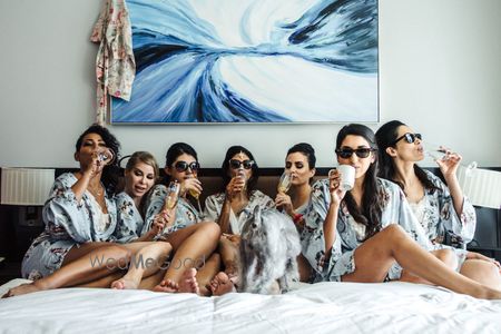 Photo of Bride and bridesmaids in robes before getting ready